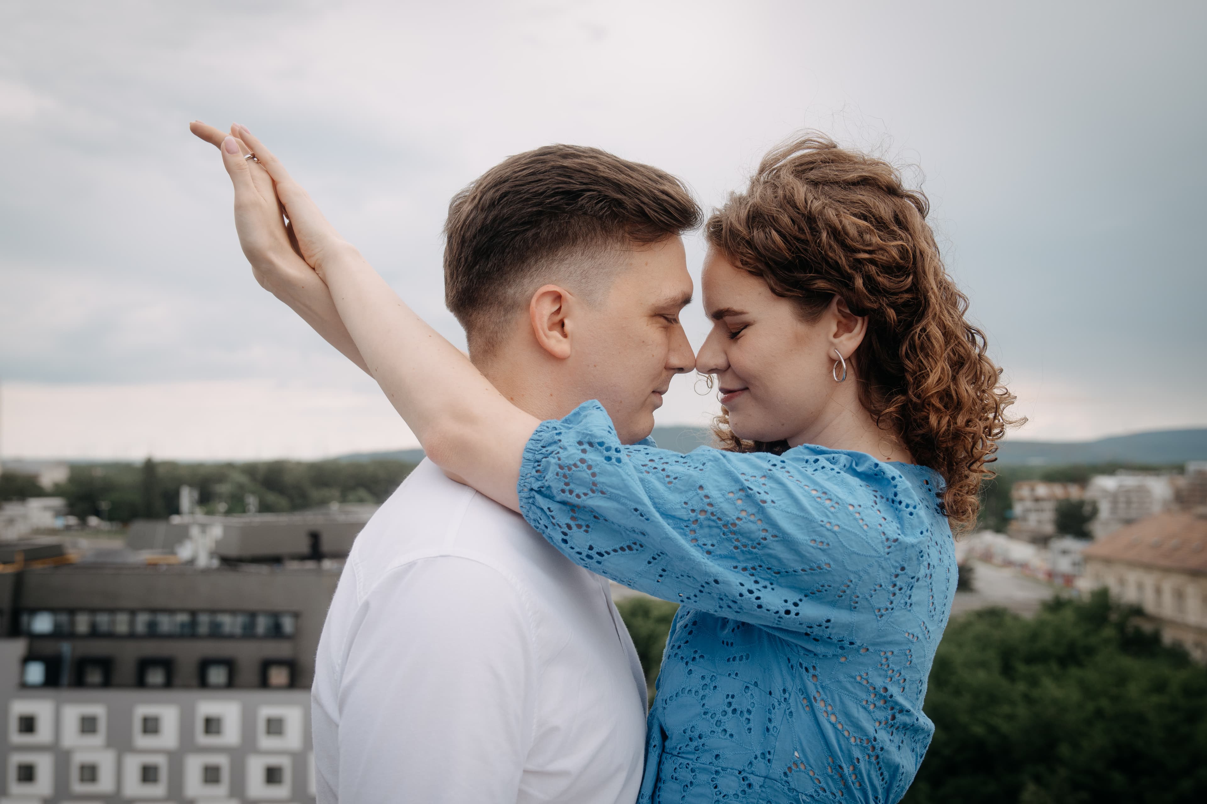 Two people, on the left a man on the left a woman holding each other in their arms.